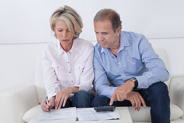 Mature couple doing family finances at home